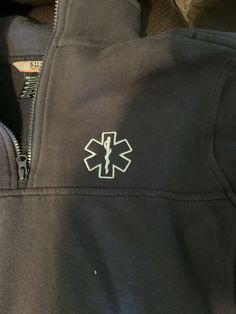 a black jacket with an emt symbol on it