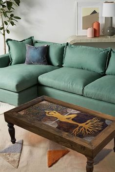 a living room with a couch, coffee table and rug