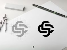 a pen, scissors and paper on top of a white table with the letter s in it