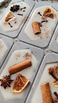 four trays filled with different types of food on top of each other and spices