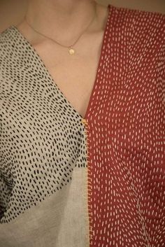 a close up of a person wearing a red and white shirt with black dots on it