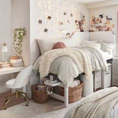 a bedroom with white furniture and pictures on the wall above the bed, along with other items