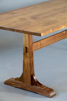 a wooden table sitting on top of a gray floor