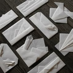 several pieces of white paper laid out on a table