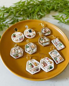 small ceramic ornaments are sitting on a yellow plate