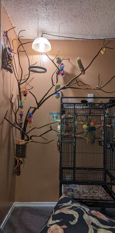 a birdcage filled with lots of birds sitting on top of a tree