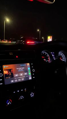 the dashboard of a car at night time