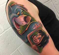 a woman with a cartoon tattoo on her arm