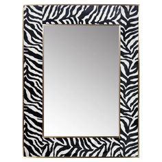 a mirror with zebra print on the frame and a white border around it's edges