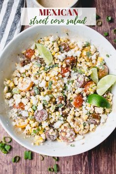 a white bowl filled with corn and vegetables next to a cup of coffee on a wooden table