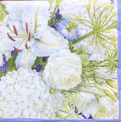 white flowers and greenery are on a blue tablecloth that has purple trim around the edges