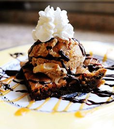 a desert with ice cream and chocolate sauce on a plate