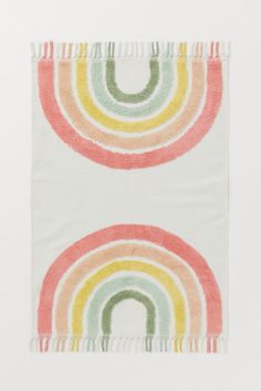 a multicolored rug with fringes on the bottom and an image of a rainbow