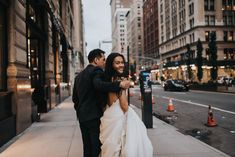 a newly married couple walking down the street