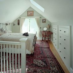 a bed room with a neatly made bed and a rug