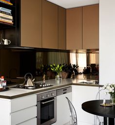 a kitchen with an oven, table and chairs