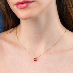 Features * Stylish red necklace with a solitaire pendant on an adjustable 18" chain, including 2-inch extension links. * Gold plated necklace for women with a round red pendant. Simple stone necklaces for women with an 8 mm red cubic zirconia stone. * Gold plated solid silver chain and pendant. This elegant gold necklace for women is made from 18K gold plated 925 Sterling Silver. * Cute gold necklaces for women and teenage girls. High-quality 18K gold plated 925 sterling silver handmade necklace Gift Solitaire Necklace With Cable Chain, Red Charm Necklace For Gift, Red Round Pendant Charm Necklace, Red Jewelry With Bezel Setting For Gift, Valentine's Day Gift Necklaces With Bezel Setting, Red Round Pendant Jewelry With Bezel Setting, Gift Solitaire Necklace With Round Pendant On Cable Chain, Round Pendant Solitaire Necklace With Cable Chain, Solitaire Necklace With Round Pendant On Cable Chain