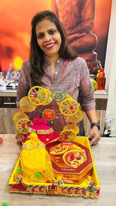 a woman standing in front of a display of decorative items