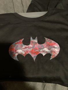 a batman t - shirt with the bat symbol painted on it