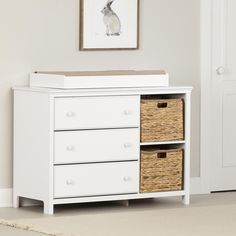 a white dresser with baskets in front of it