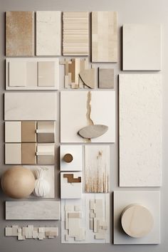 an assortment of white and beige tiles arranged on top of each other with different shapes