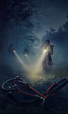 a group of people riding bikes in the woods at night with flashlights on their heads