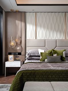 a bedroom with a bed, nightstands and pictures on the wall behind it in shades of green