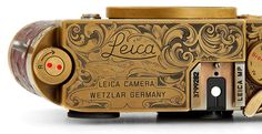 an old fashioned camera with the word leica printed on it's front side