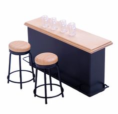 three stools are next to a bar with four glasses on the top and bottom