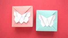 two origami butterfly boxes on a red background