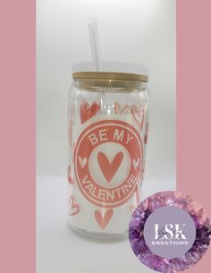 a pink and white mason jar with a straw in front of it that says be my valentine