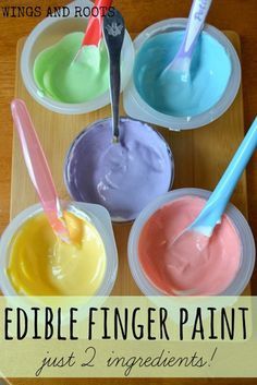 four different colors of edible finger paint in plastic cups with spoons on the side