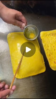 two square shaped food items being prepared on a table