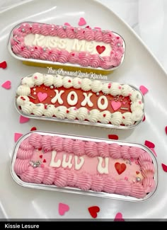 three valentine's day desserts in tins on a white plate with hearts