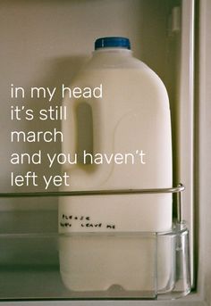 a bottle of milk sitting on top of a shelf next to a glass container with the words in my head it's still march and you haven't left yet