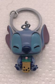 a keychain with a cartoon character on it sitting on a white table top