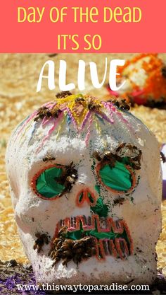 a white skull with green eyes and the words day of the dead it's so alive