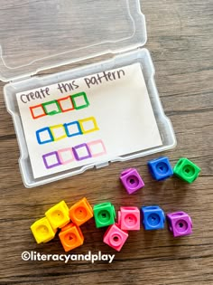 a plastic container filled with colorful legos and some writing on the paper that says create this pattern