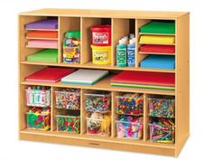 a child's wooden storage unit with lots of crafting supplies on the shelves