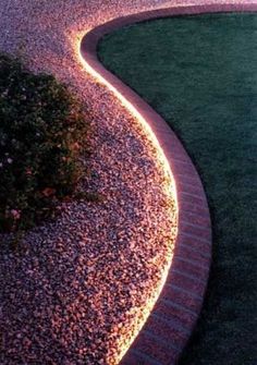 an image of a garden path that is lit up by lights on the side of it