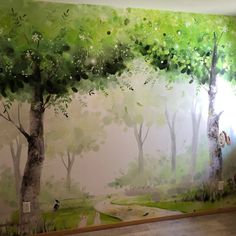 a painting on the wall of a room with trees painted on it and a person walking in the distance