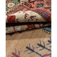 two rugs with different colors and designs on them, one is beige and the other is blue