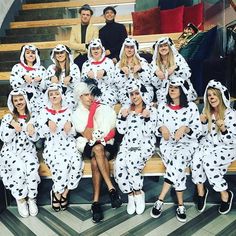 a group of people in dalmatian costumes posing for a photo on the stairs