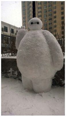 there is a giant snow man standing in the snow