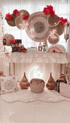 a white table topped with lots of plates and bowls on top of a floor next to a window