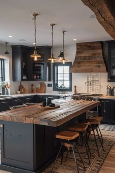 a large kitchen with an island in the middle and stools at the counter top