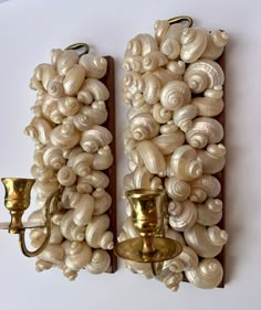 two wall sconces made out of seashells