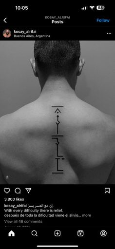 the back of a man's neck with an arrow tattoo on it