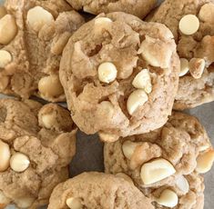 a pile of cookies with white chocolate chips