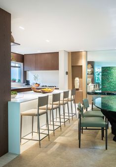 a kitchen filled with lots of counter top space next to a dining room table and chairs